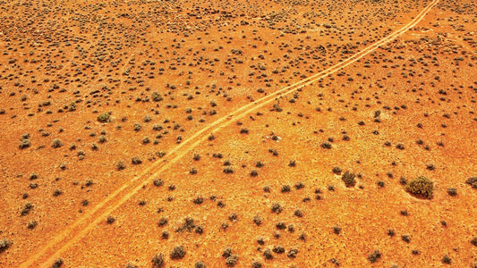 Australia top 10 must visit 4x4 destinations drone view of track crossing desert. I Go Overland Blog.