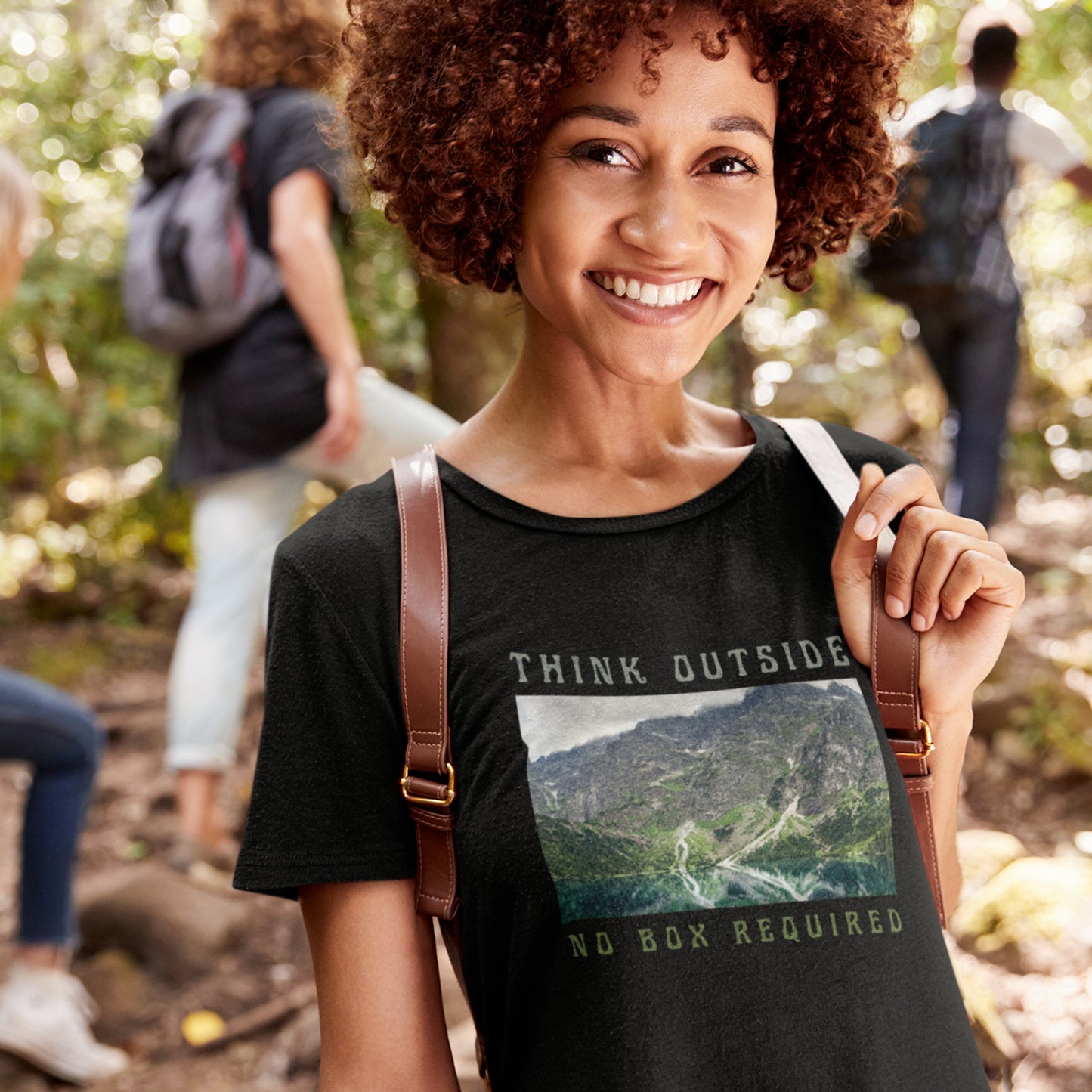 overland clothing tshirt think outside no box required smiling woman at a group hike